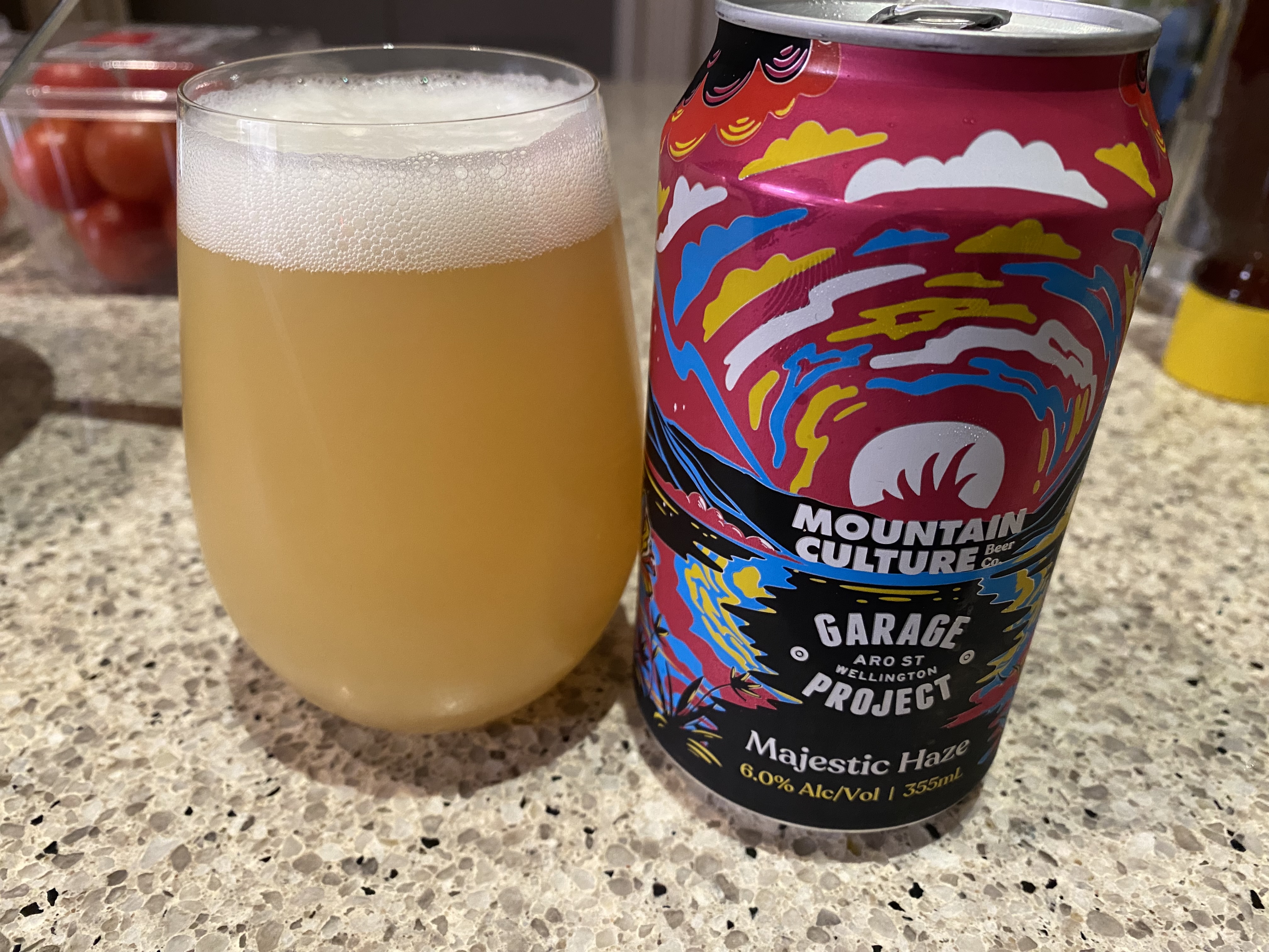 A can of Mountain Culture Majestic Haze, in a psychedelic can, and the beer next to it poured into a glass