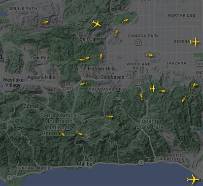 A FlightRadar24 screen shot of Los Angeles showing a large number of fire fighting helicopters and planes